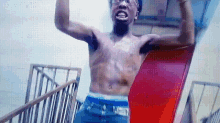 a shirtless man is standing on a staircase with his arms outstretched .