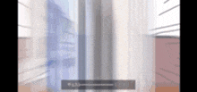 a blurry picture of a person standing in front of a fridge .