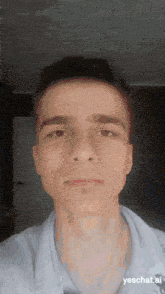 a young man is taking a selfie with the website yeschat.ai displayed at the bottom