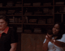 a group of people are clapping in a room