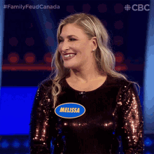 a woman wearing a sequined top has a name tag that says melissa