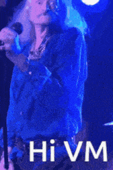 a man singing into a microphone with the word hivm written on the bottom