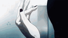 a close up of a person 's hand with a black nail polish .