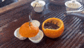 a bowl of tea sits next to an orange peel