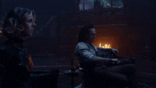 a man sits in a chair while a woman stands in front of him and says -sylvie growls