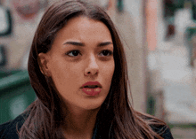 a close up of a woman 's face with a serious expression