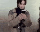 a man is holding a cell phone in his hands .