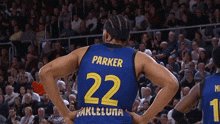 a basketball player wearing a blue jersey with the number 22 on the back
