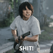 a man holding a shotgun with the word shit written on the bottom