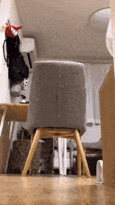 a gray chair is sitting in a room next to a desk