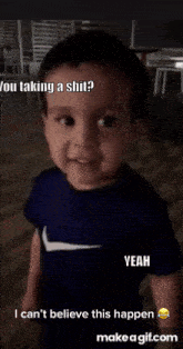 a baby is wearing a blue nike shirt and asking if he is taking a shit