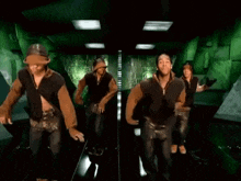 a group of men and women are dancing in a hallway .