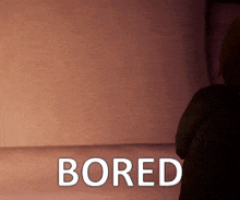 a picture of a person sitting in front of a wall that says bored