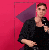 a young man is holding a microphone with the word timeplayer on it