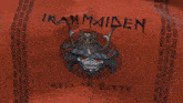 a red iron maiden shirt with a samurai helmet on it