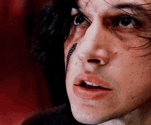 a close up of a man 's face with a snake on his nose