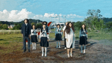 a group of people standing in a field with one wearing a white shirt with the number 10 on it