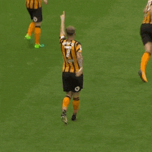 a soccer player with the number 7 on his shorts is standing on the field