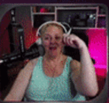 a woman wearing headphones is sitting in a chair in front of a computer .