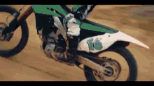 a person on a dirt bike with the number 16 on it