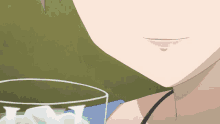 a girl drinking a green liquid from a glass