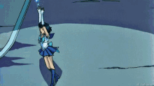 a girl in a sailor suit is holding a blue object in her hands