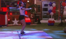 a woman is dancing on a dance floor in a room decorated for independence day .