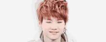 a close up of a young man with red hair making a funny face with his eyes closed .