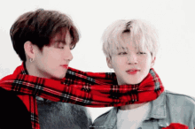 a man with a red plaid scarf around his neck
