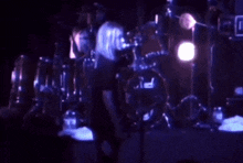 a person playing drums with a pearl drum set in the background