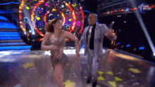 a man and a woman are dancing on a stage with a dancing brasil logo in the background