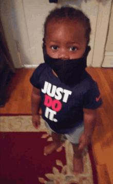 a young boy wearing a just do it shirt