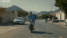 a man riding a motorcycle down a street with the year 2005 on the bottom of the screen