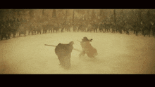a man with a sword is standing in front of a large crowd of people