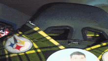 a green and yellow plaid blanket with a picture of a man