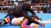 a man is wrestling another man in a ring .
