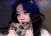 a girl is holding a small dog with the words bye bye written on it