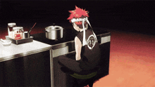 a man sitting on a stool in a kitchen wearing a black shirt that says ' tokyo ' on it