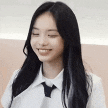 a young woman with long black hair is wearing a white shirt and tie .