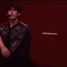 a man in a black jacket is holding a woman 's hand and has the name bella / @gunwoo on the bottom right