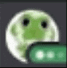 a blurred image of a green frog looking out of a hole in a wall .