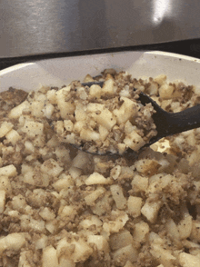 a spoon is being used to stir a pot of food