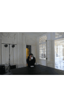 a man stands in an empty room with a checkered floor