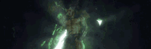a man with horns is surrounded by green smoke in a dark room .