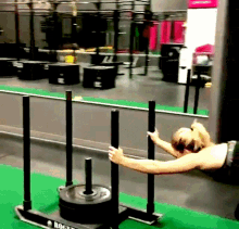 a woman is pulling a sled with a rogue logo on it