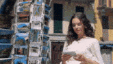 a woman is looking at a postcard that says " italy " on it
