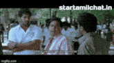 a group of people are talking to each other on a street .
