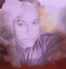 a close up of a man 's face with a hand on his forehead