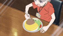 a person with a lanyard around their neck is sitting at a table with a plate of food