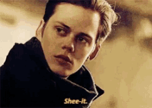 a close up of a person 's face with the words shee-it written on it .